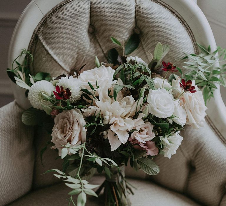 Classic bridal bouquet complete with white roses and tied with raw edge ribbon