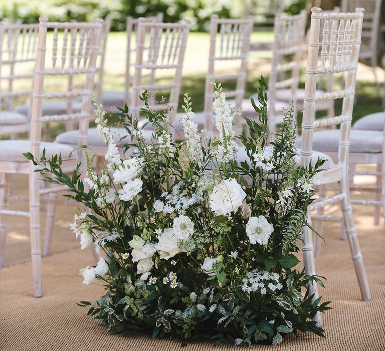 Beautiful white and green wedding aisle flowers with white flowers and foliage 