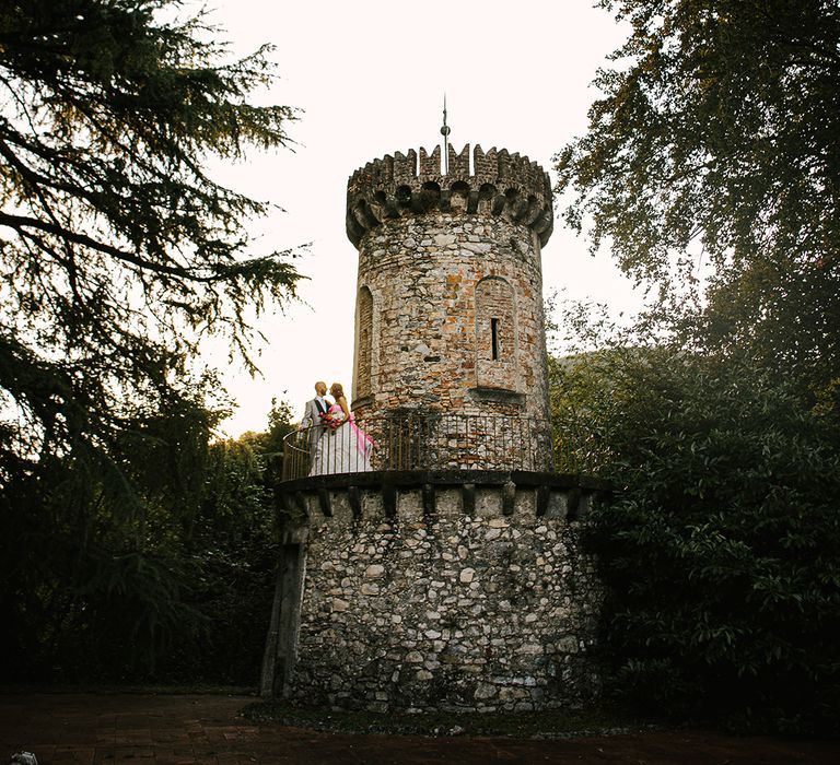 italian villa wedding with bride and groom portrait in front of a castle