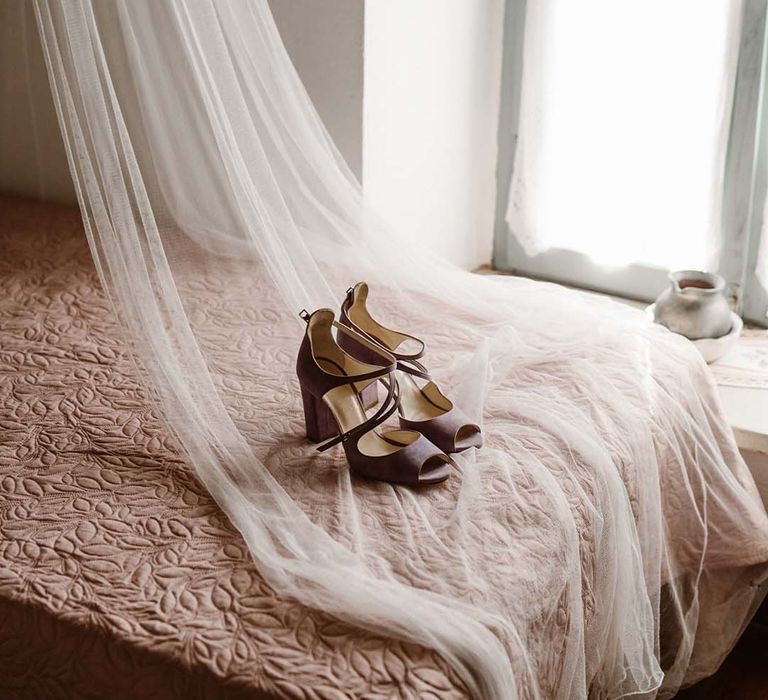 lilac block heel wedding shoes on the bed