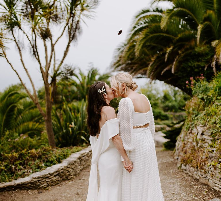 Brides in off the shoulder wedding dress and bride in two piece top and skirt for relaxed outdoor wedding 