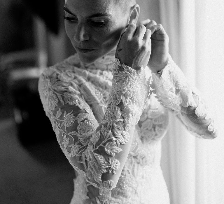 Bride wearing lace long sleeve wedding dress with short blonde hair 