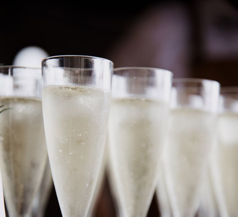 Glasses of champagne lined up on the mobile bar for wedding guests 