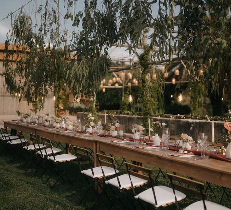 Tenuta Savoca rustic al fresco wedding tablescape with rattan boho lighting for destination wedding 