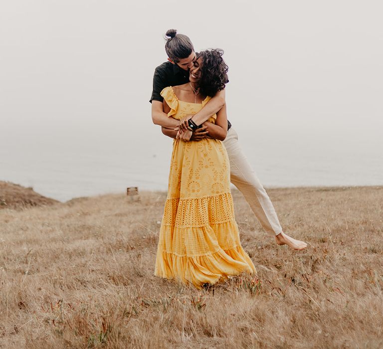 Bride in yellow maxi dress at coastal elopement 