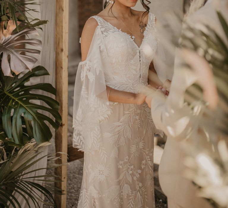 Bride in lace cold shoulder wedding dress