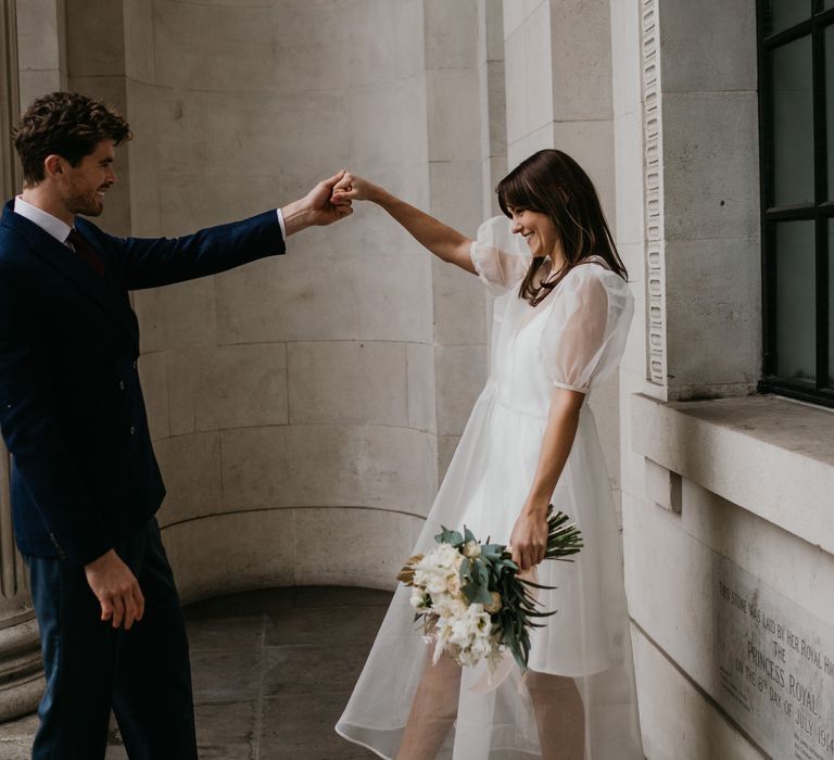 Bride and groom dancing at Intimate Old Marylebone Town Hall with Bride in Story Of My Dress gown