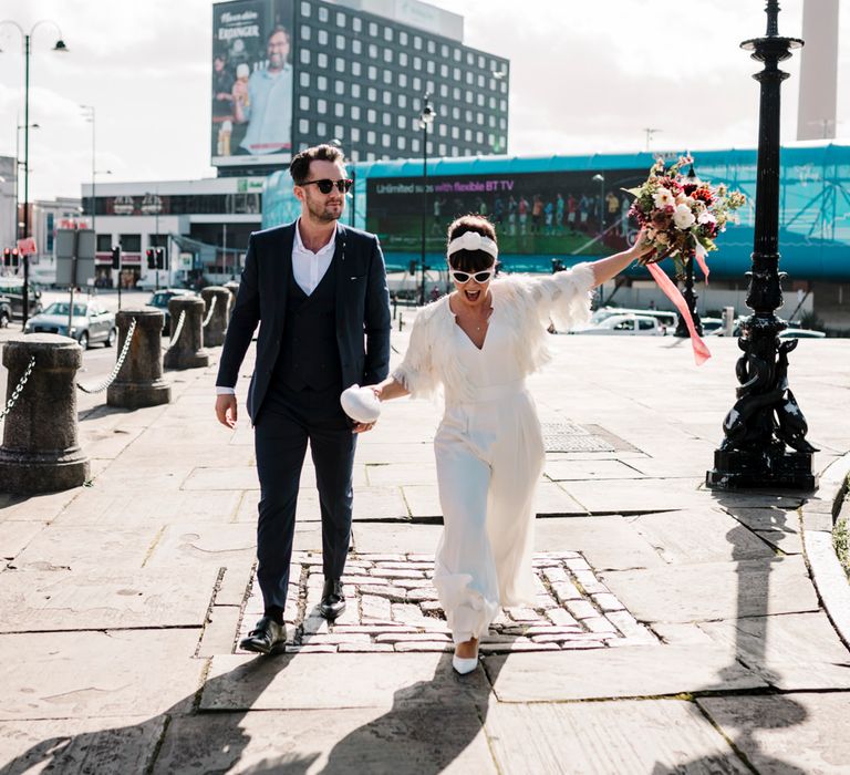 Bride and groom walking through Liverpool at micro wedding 