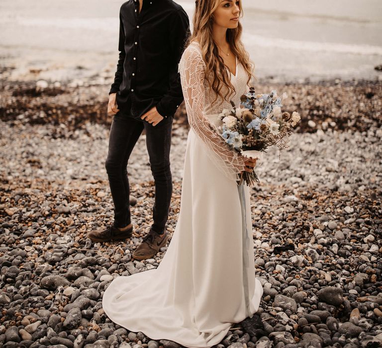 Bride in wedding dress with long lace sleeve detail 