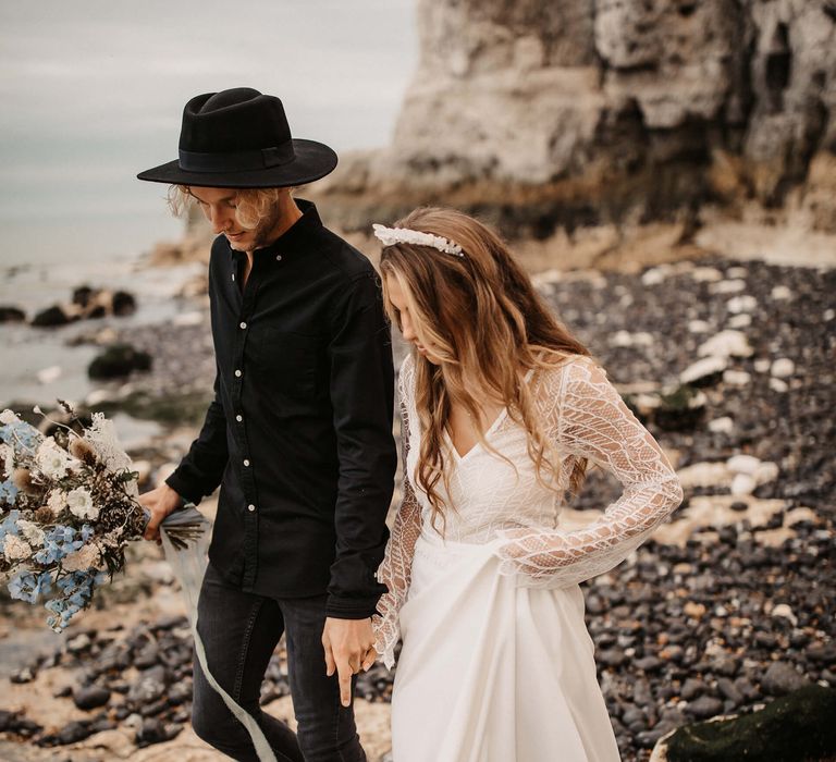 Couple holding hands at Kent coastal elopement 