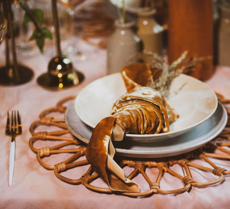 Table set up for sustainable wedding ideas with gold crushed velvet napkin