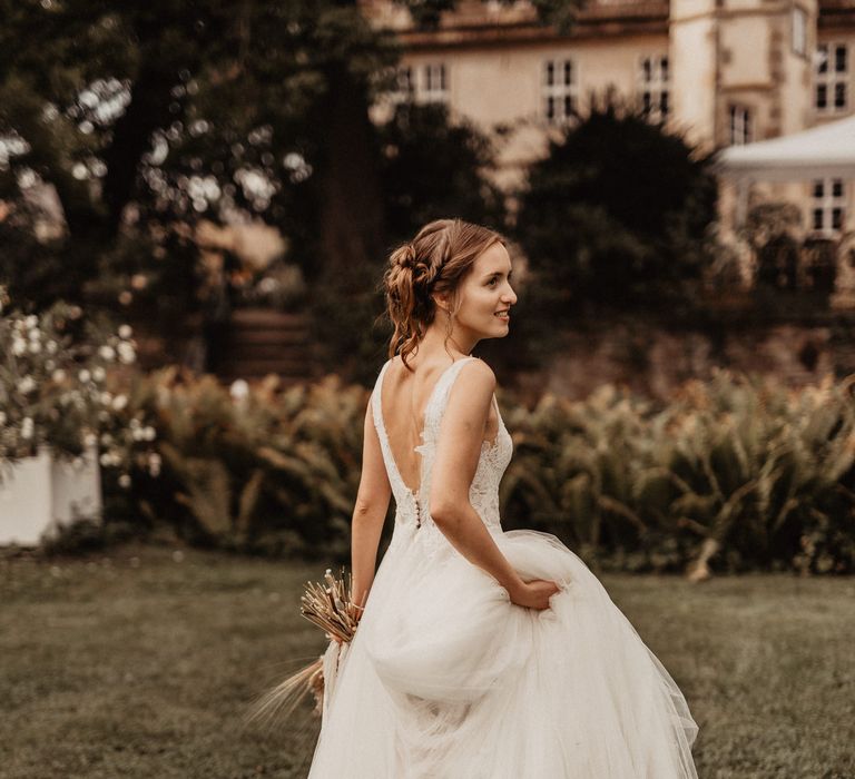 Bride in backless Watters wedding dress