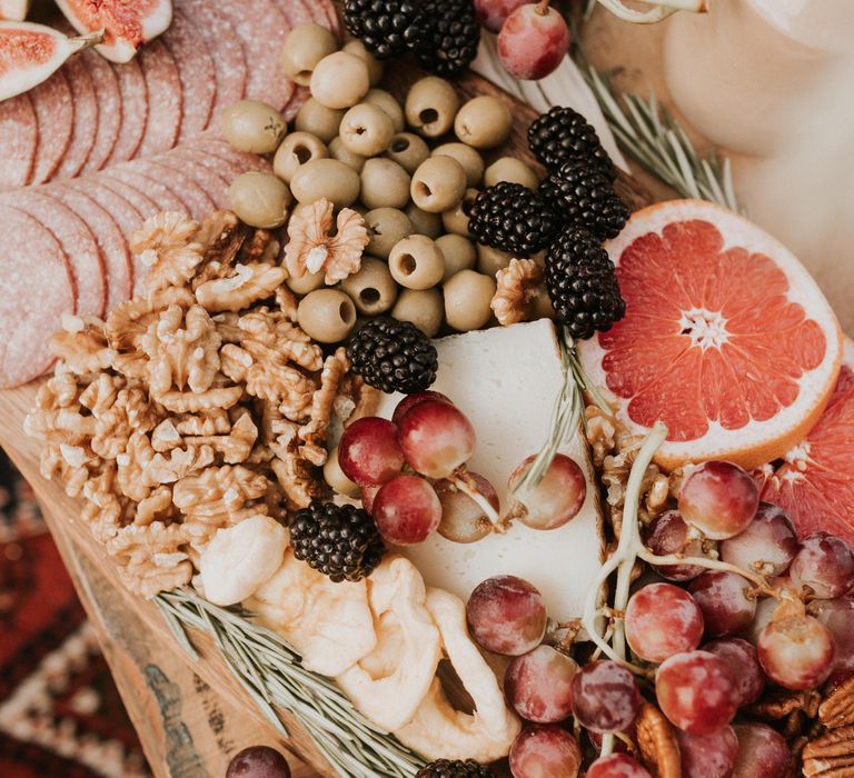 Grazing plate with olives, walnuts and oranges 