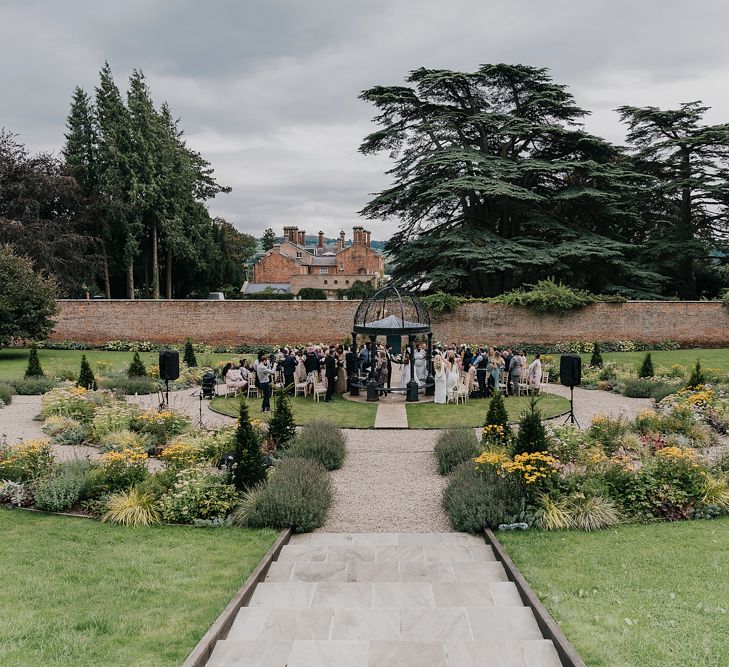 Outdoor wedding ceremony at Garthmyl Hall in Wales