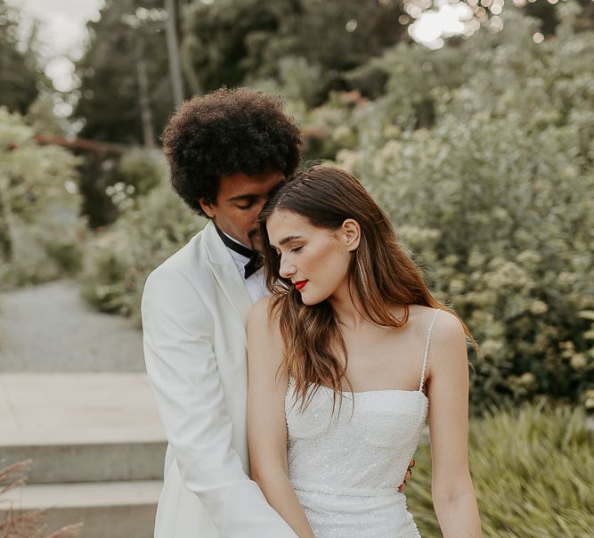 Bride in a white sequin wedding dress with fitted bodice and thin straps 