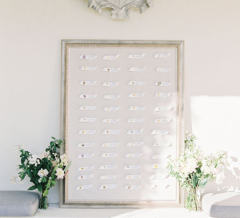 White ribbon table seating plan for English garden party wedding