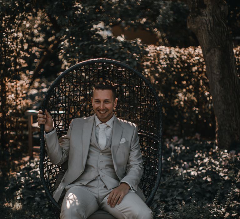 Groom in light grey wedding suit