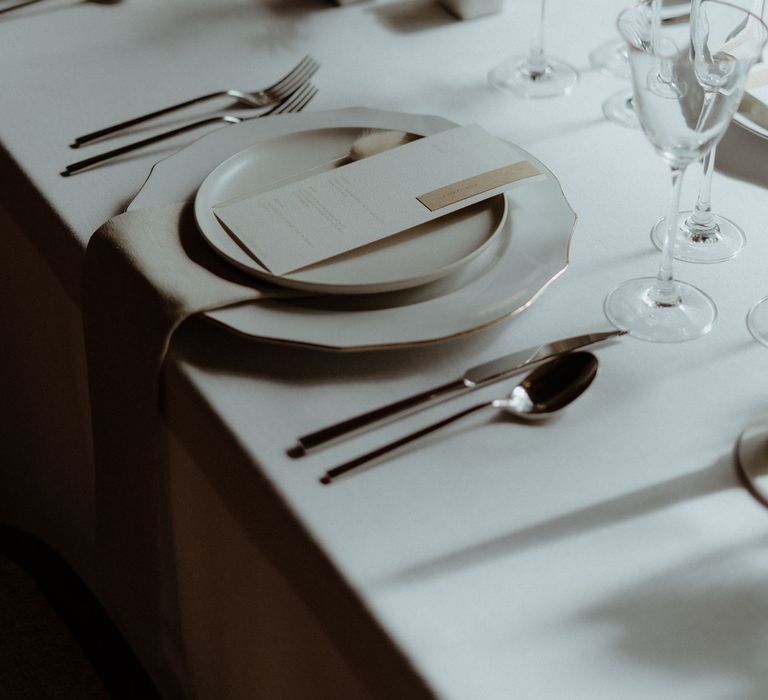 Minimalist decor for a simple elegant wedding table including dried grasses, bunny tails and white ceramics.