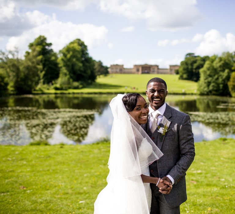 Bride & groom embrace outdoors in the lush grounds of the Stowe House