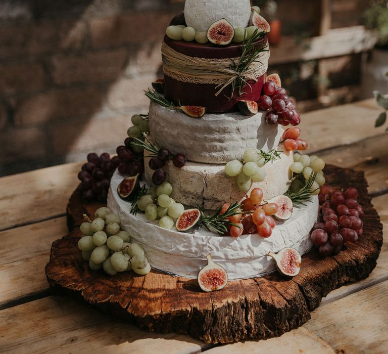 Cake topper with the couples initials for a cheese tower wedding cake 