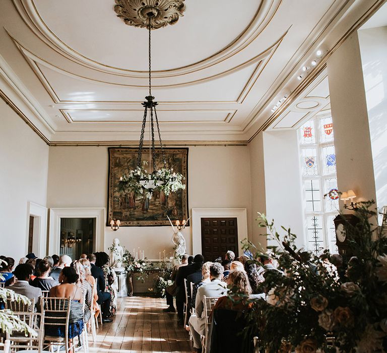 Elmore Court wedding ceremony room with romantic white, pink and green foliage floral arrangements 