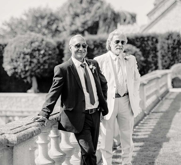 Black & white image of wedding part stood outside on wedding day at Euridge Manor 