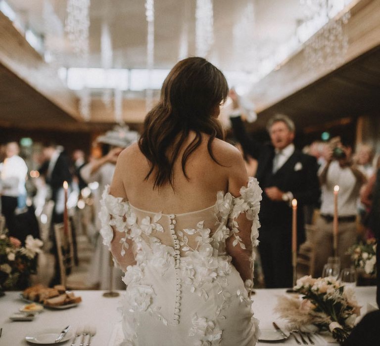 Off the shoulder wedding dress with appliqué flower detail