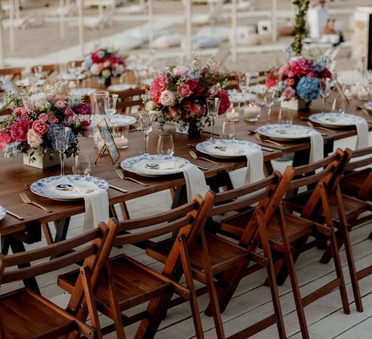 Long wooden banquet tables in Greece 