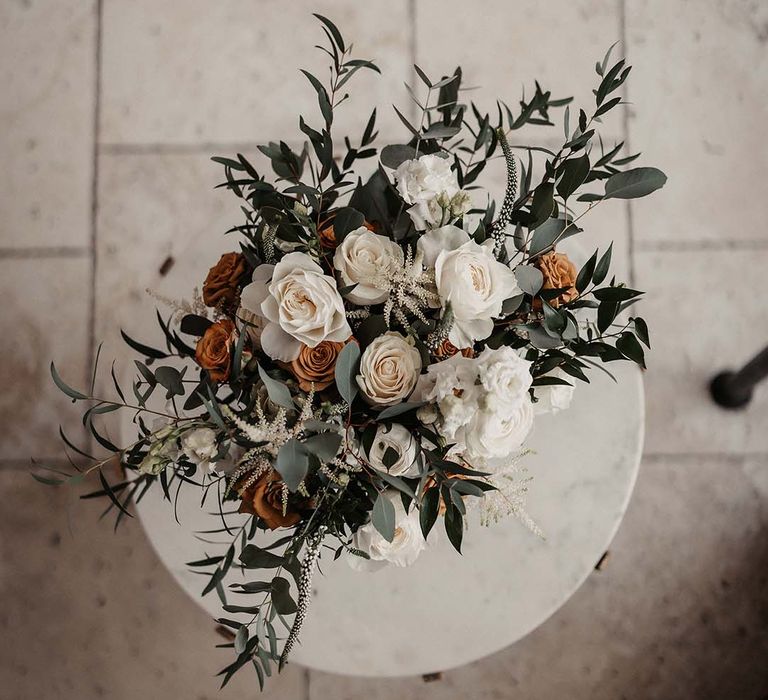 Wedding flowers with white and orange roses and greenery for earth toned spring wedding