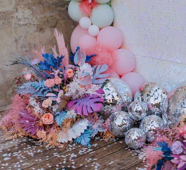 Holorgraphic wedding decor, pastel flowesr and cluster of silver glitter balls wedding decor 