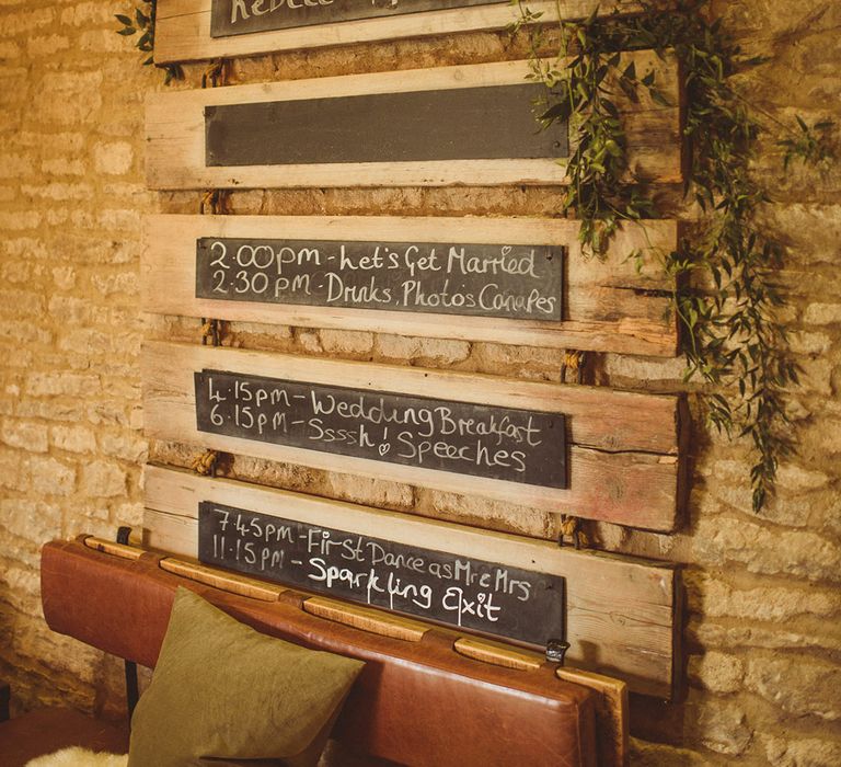 Order of the day wedding sign made up of chalkboard on wooden planks for rustic and classic wedding at Tythe Barn 