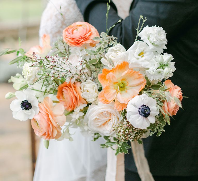 romantic peach and white wedding bouquet with anemones, roses, ranunculus and Icelandic poppies 