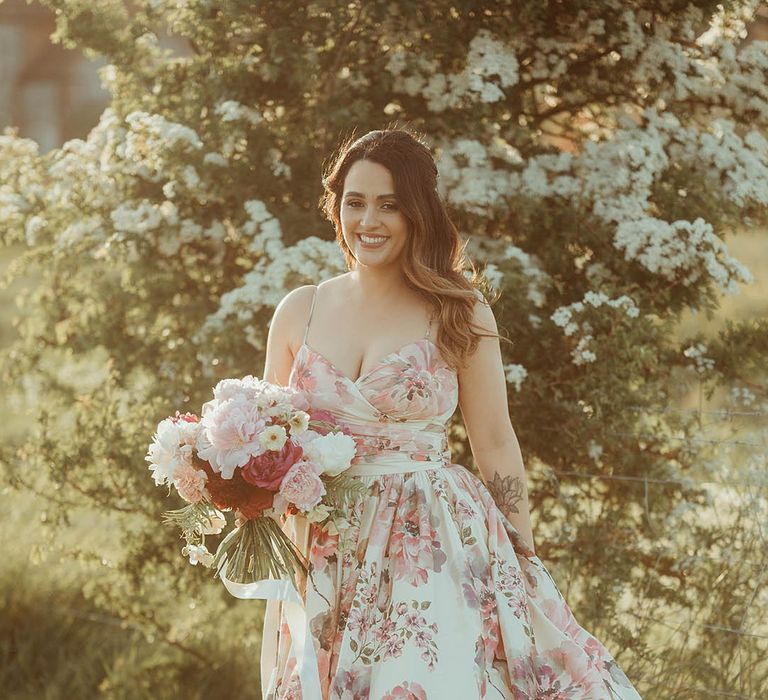 Bride with soft wavy hair and a pink flower hand painted silk wedding dress from Wendy Makin with pink and white flowers bouquet 