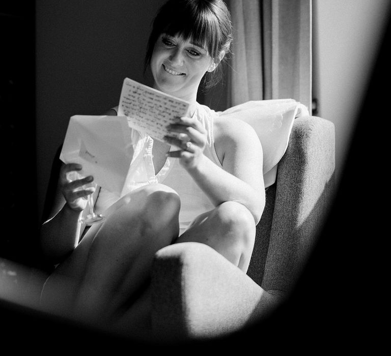 Bride reads letter on the morning of her wedding day