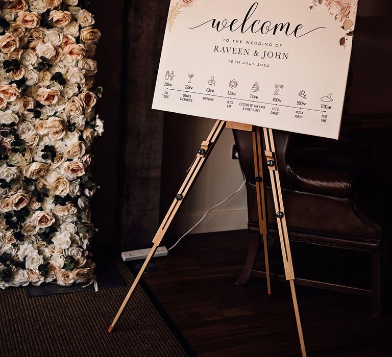 Welcome wedding signage complete with floral illustration to corners on wooden easel 