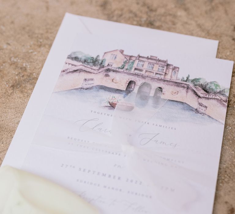 Wedding stationery wedding invitations with sketch of the wedding venue tied with pale green ribbon 