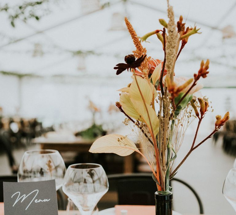 natural dried wedding flowers in a black vase 