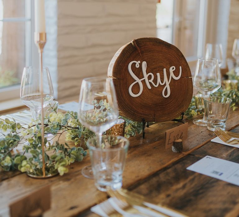 Rustic coastal wedding with tree trunk slice wedding table names with 3D lettering 