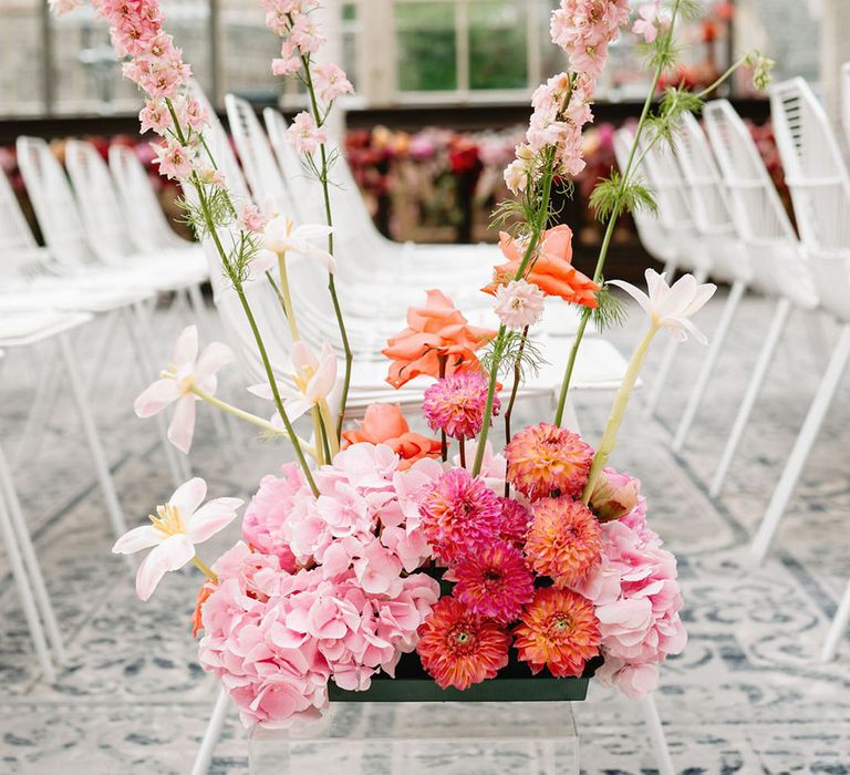 Hydrangeas, reflexed tulips, dahlias and more make up the colourful pink aisle flower decorations 