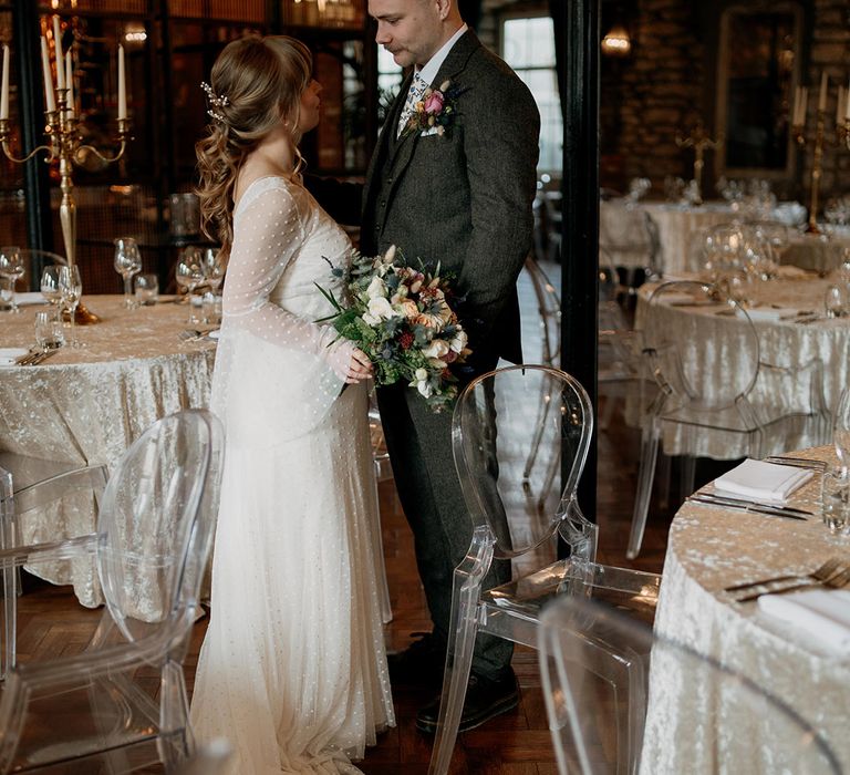 The bride and groom pose together at Holmes Mill industrial wedding venue in Lancashire 