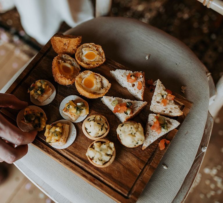 Wedding canapés on wooden sharing platter for guests to eat 