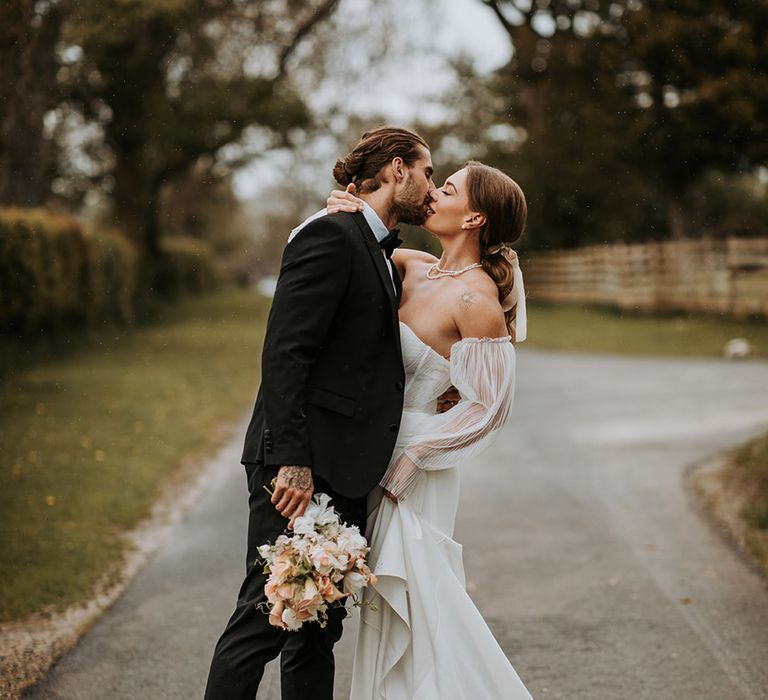 Romantic wedding with bride and groom kissing at Eden Barn 