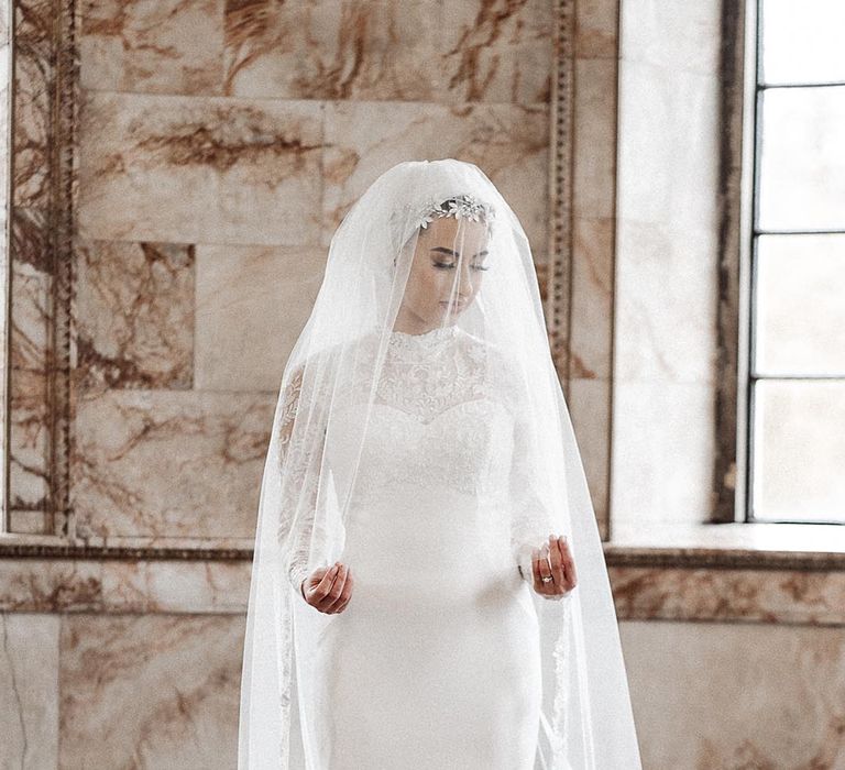 Islamic wedding with the bride in a full long sleeve lace wedding dress and veil 