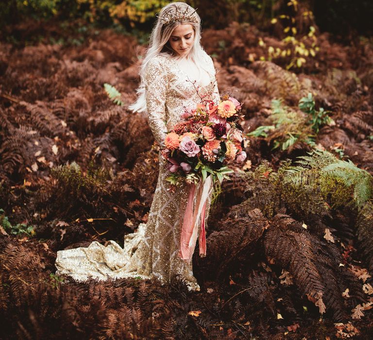 Bride wearing long sleeve gold sequin wedding dress 