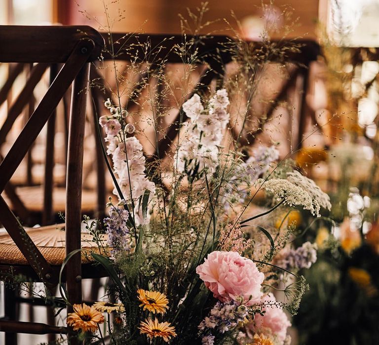 Wildflower aisle decorations with pastel flowers for rustic barn wedding 