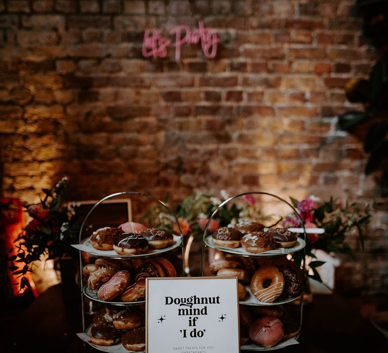 Doughnut tower alternative to wedding cakes with funny wedding sign 