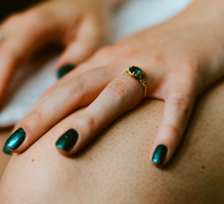 Bride with dark emerald green shimmer wedding nails 