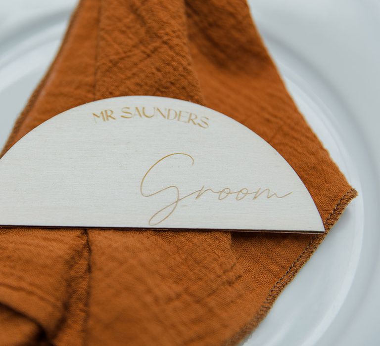 Burnt orange wedding napkin with wedding place name