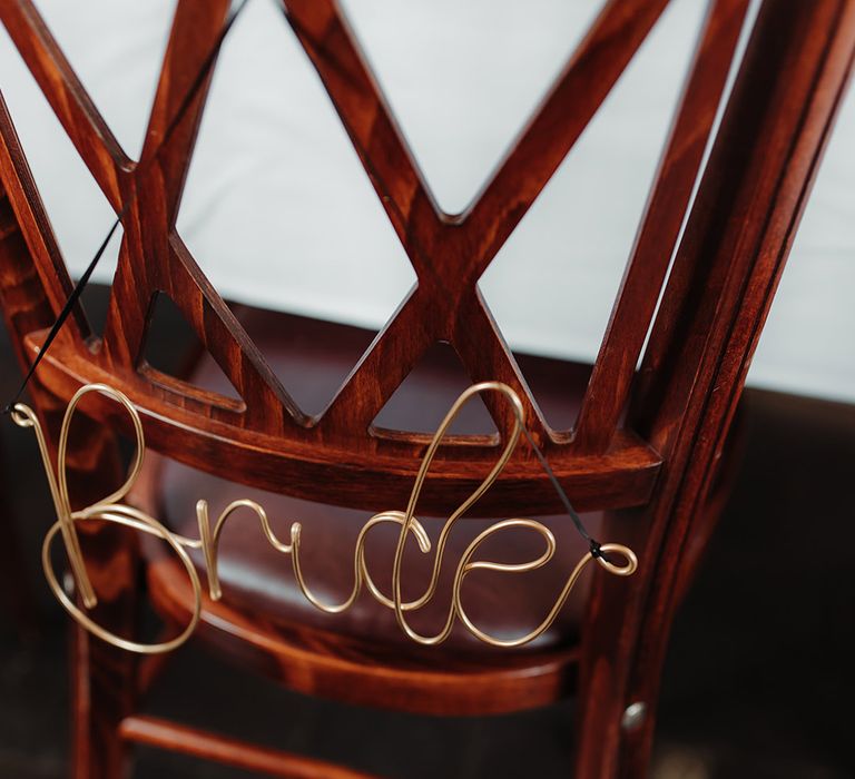 Gold wire chair decoration to reserve the seat for the bride 