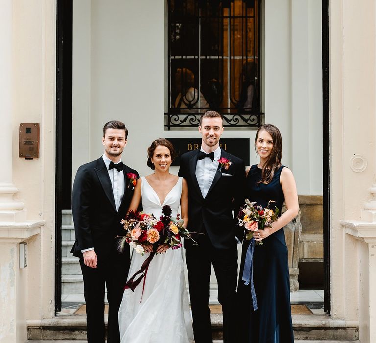 Bride and groom with best man and bridesmaid at Carlton House Terrace wedding 